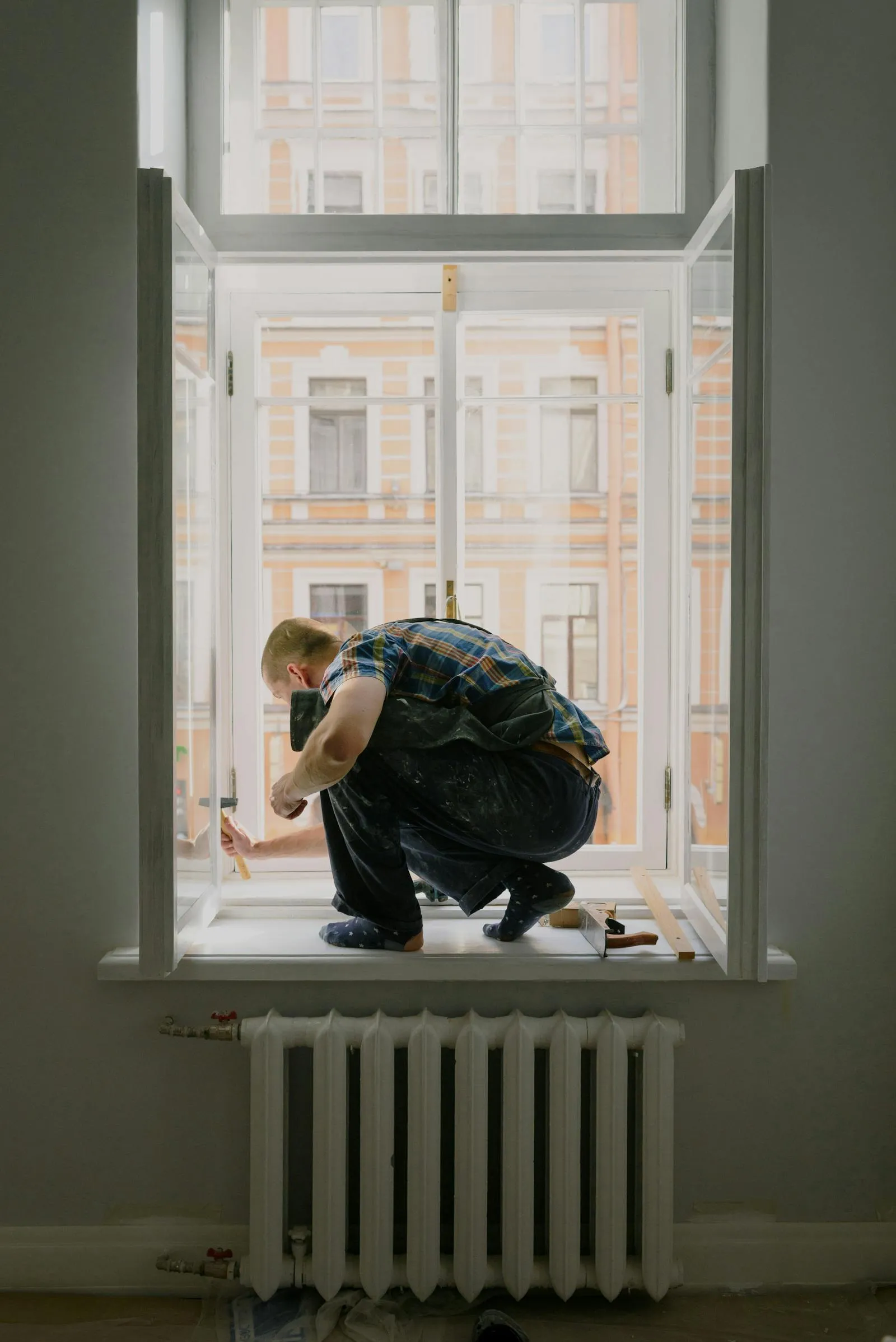 Technician repairing a residential window
